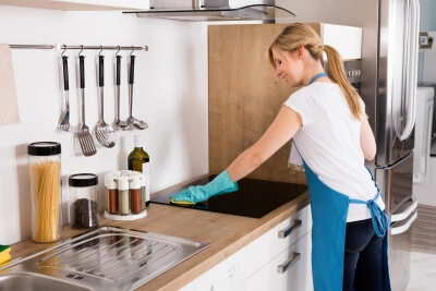 caregiver cleaning in the kitchen